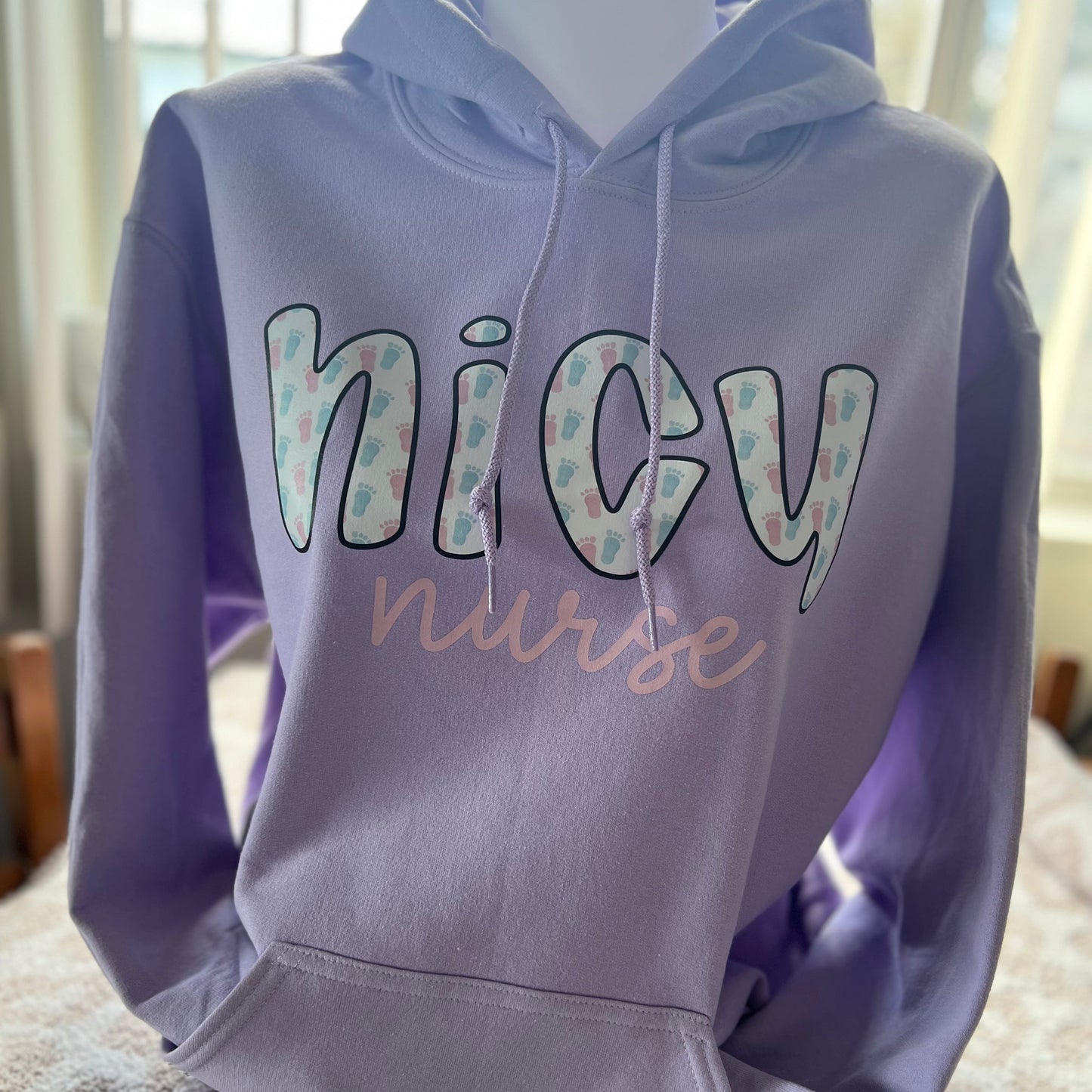 A purple hoodie with the text 'NICU nurse' printed on the front.